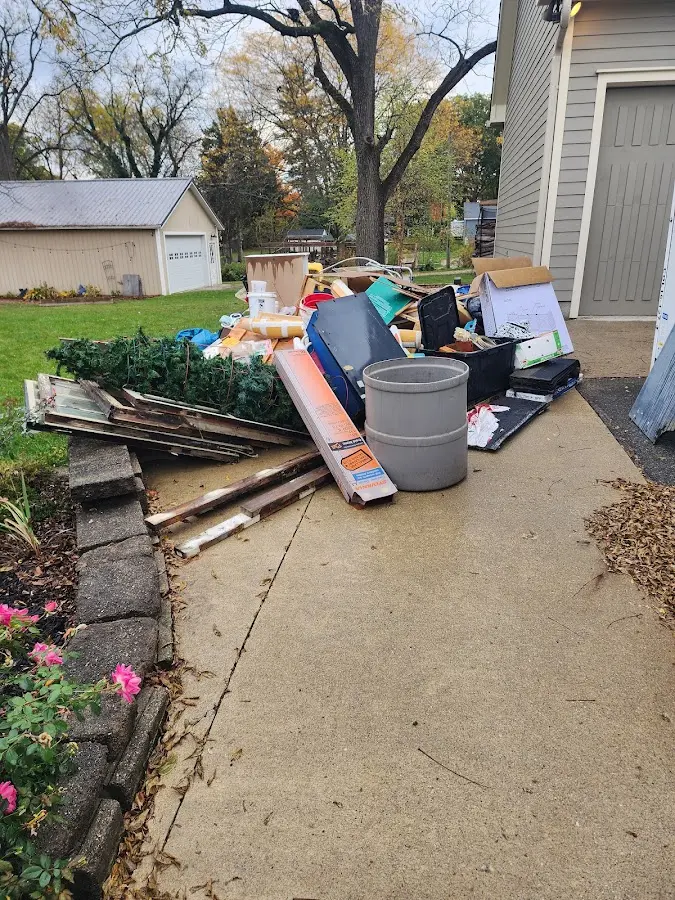 Dumpster being loaded with debris for Commercial Dumpster Rental in Gadsden